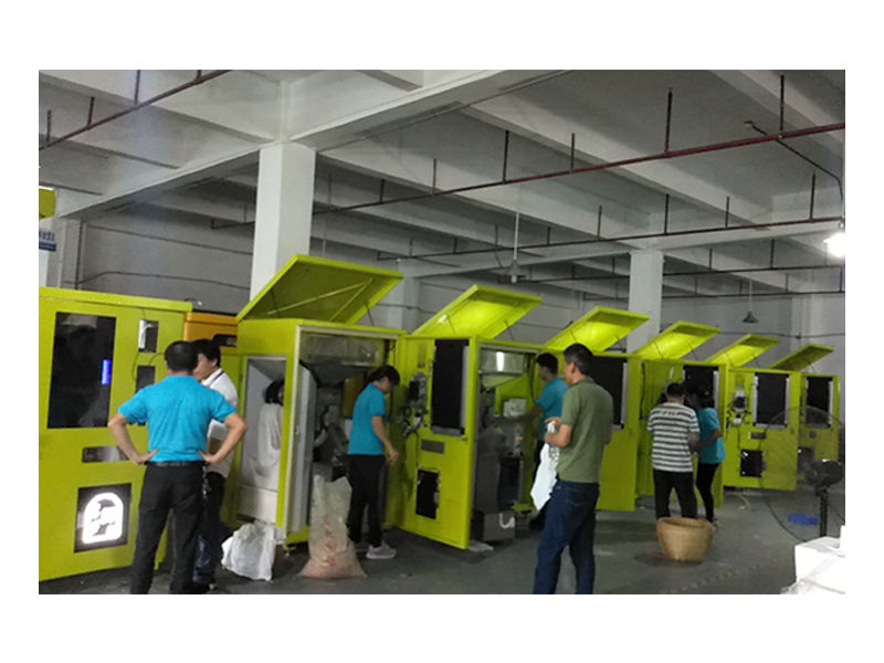 Workers working on yellow vending machines